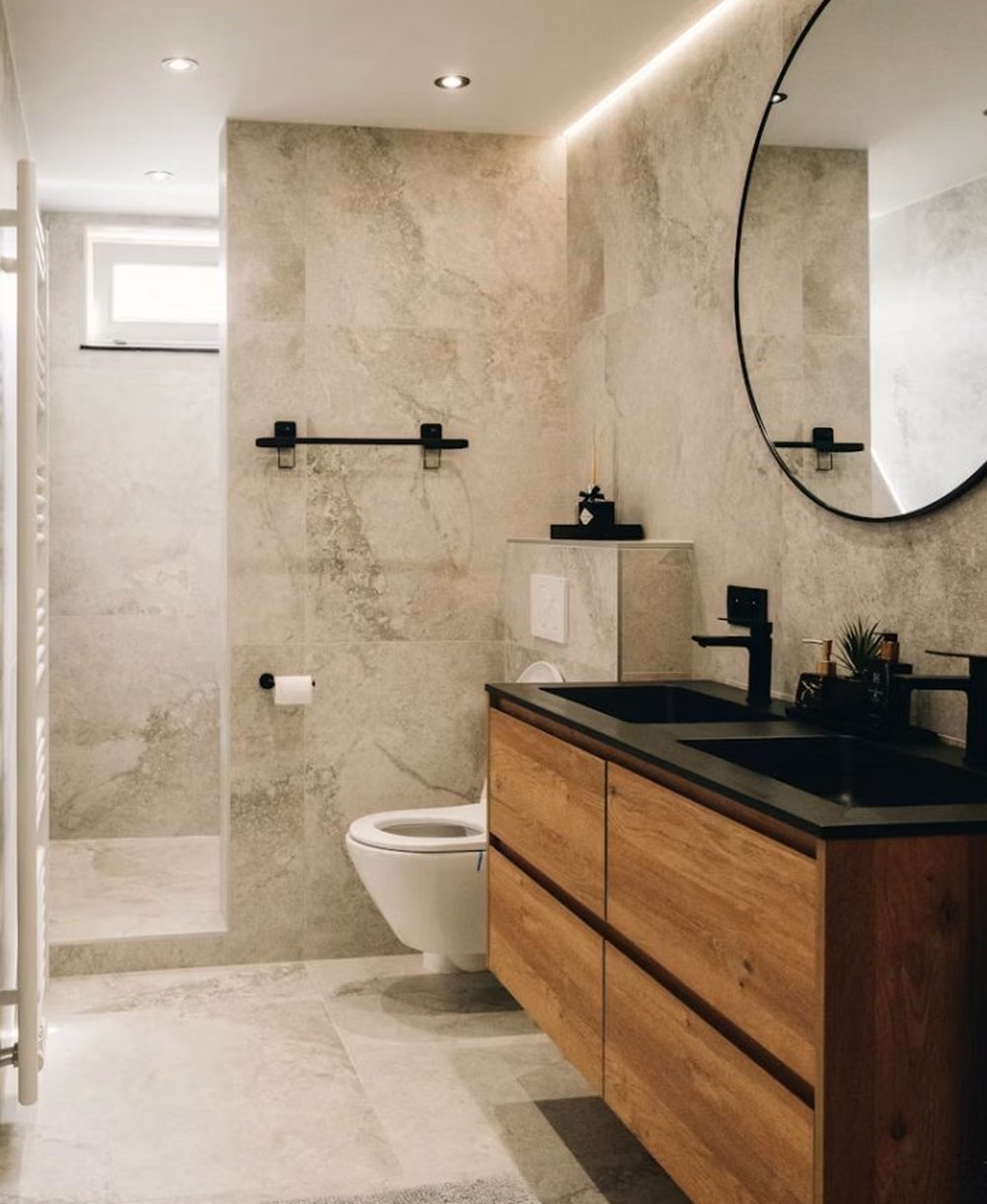 Hard finishes — marble and tile, wood cabinetry and bathroom fittings sourced by Felix Deco